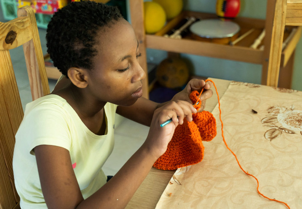 External student knitting at Kay Eliane