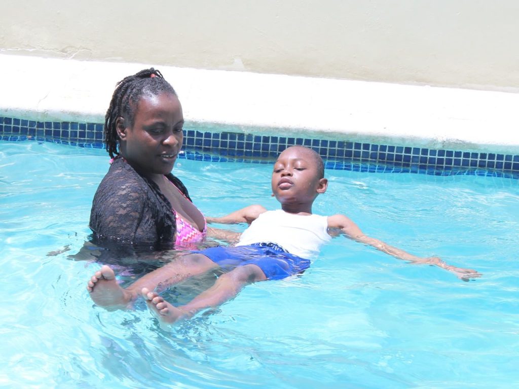 A mother and child floating in the Tabarre rehab centre pool